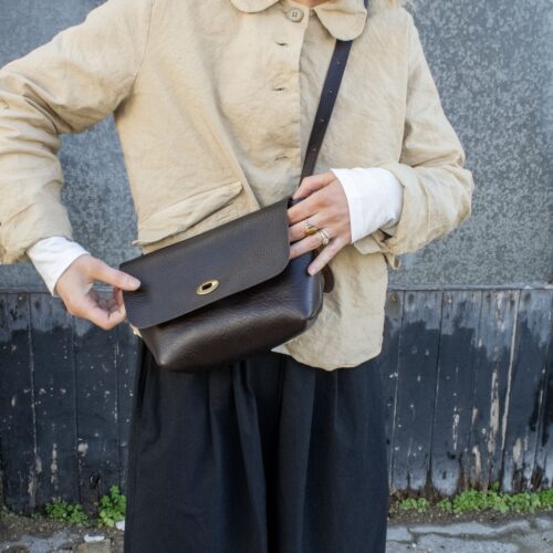 P Kirkwood - SS25 - MIKA bag- model - Liquorice- hands.